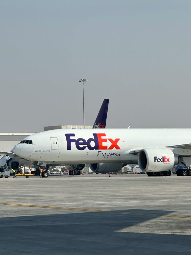 pexels photo 28714395 28714395 FedEx cargo aircraft parked at Dubai International Airport on a clear day.